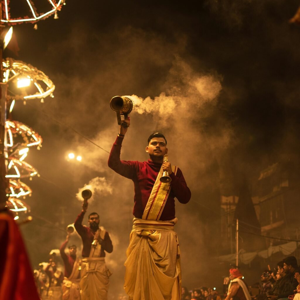 Vibrant scene of Ganga Aarti ceremony in Varanasi with priests in traditional attire.