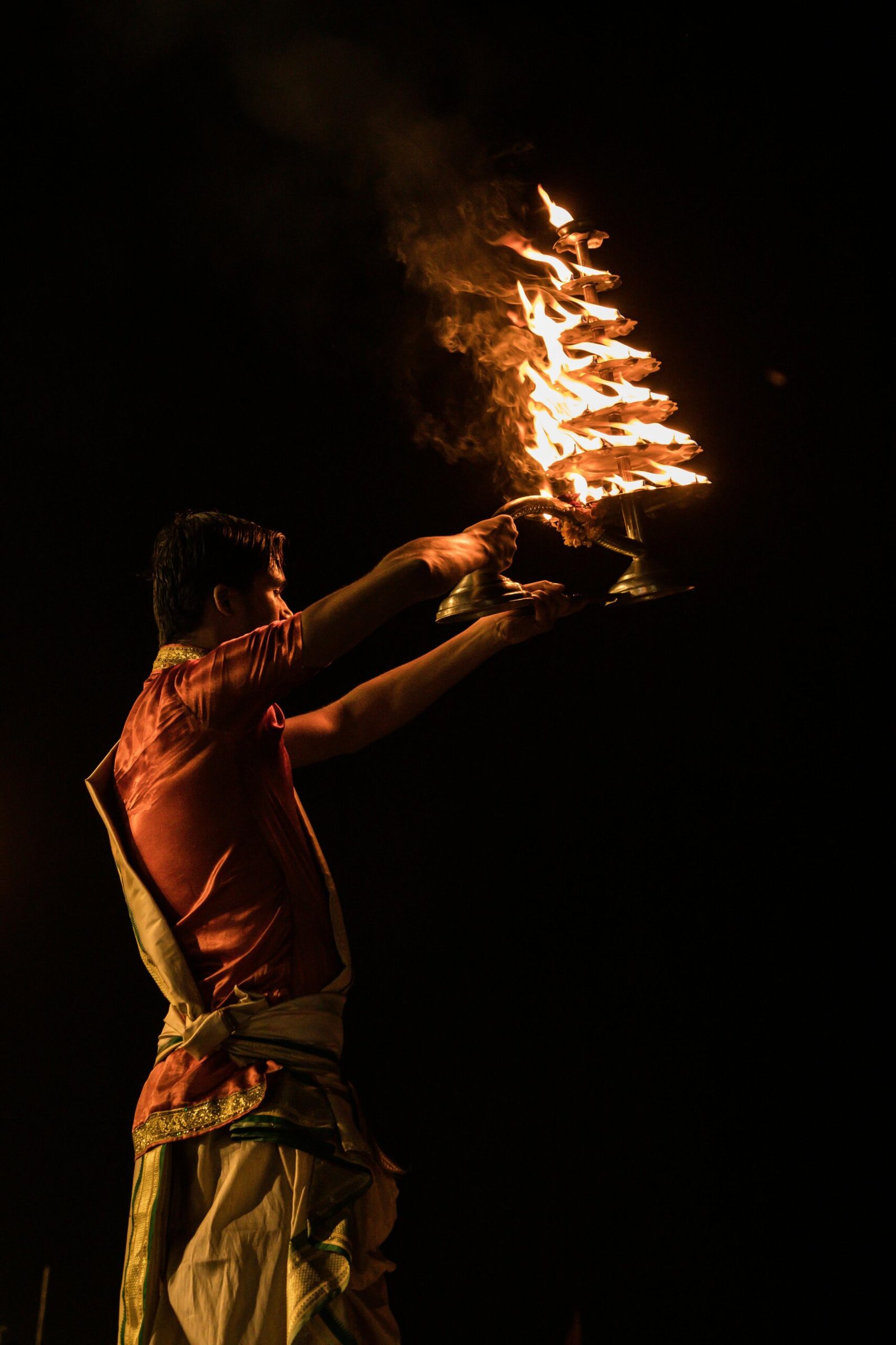 An intricate Ganga Aarti ritual performed on the ghats of Varanasi, showcasing traditional Indian spirituality.